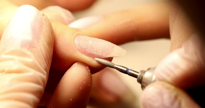The removal of the gel coating from your nails, manicure hardware.  Beauty salon, nail service master, manicure training courses.