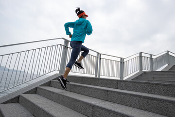 Fototapeta na wymiar Fitness sports woman runner running on seaside trail