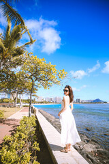 Girl wearing white long dress by the sea, Honolulu, Oahu, Hawaii