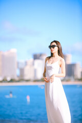 Girl wearing white long dress by the sea, Honolulu, Oahu, Hawaii