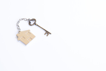 Home key with house keychain on white background
