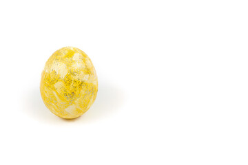 Yellow Easter egg decorated with glitter isolated on a white background. Shiny golden colored egg