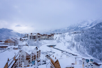 Winter aerial view of the Ski Resort Rosa Khutor. A complex of hotels on the site of the former Olympic village of Rosa Plateau at an altitude of 1170 m from sea level. Krasnaya Polyana, Sochi, Russia