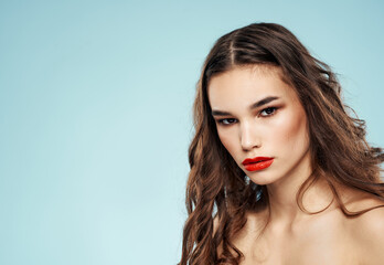 Fototapeta premium Sexy woman model on blue background cropped view of naked shoulders red lips
