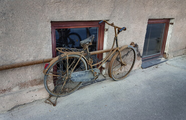 Fototapeta na wymiar Old and Rusty Bike on the Street. Abandoned vehicle