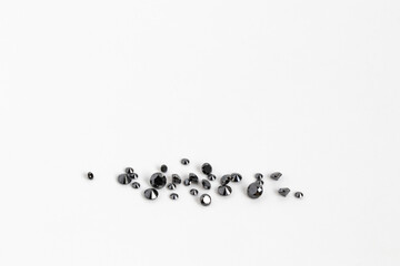 Treated Black Diamonds on White Background. Brilliant Cut Gemstones. Faceted