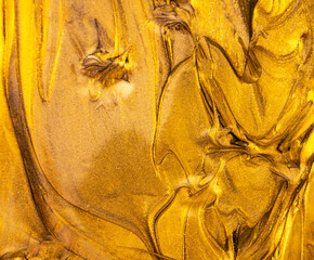 Golden paint texture with bright yellow highlights