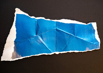 Shiny ripped and crumpled paper backdrop with brush strokes and paint texture.