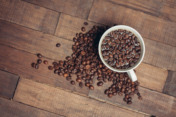 cup with coffee grains on a wooden table aromatic drink