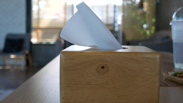 tissue paper in a wooden box at a coffee shop.