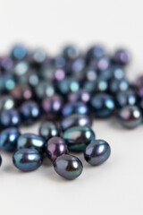Dark Peacock Oval Pearls. Natural Freshwater Pearl Background. Colorful Luster