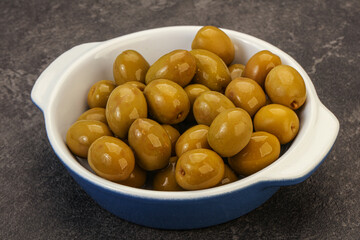 Green pickled olives in the bowl