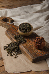 Chinese tea Milk Oolong Tea. Dry loose Chinese tea leaves on wooden background. Space for text.