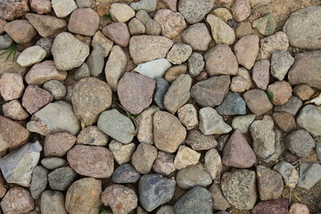 Old rural stone pavement, cobblestone background texture 