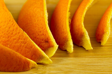 Orange peels on a chopping board. Soft light from two lamps