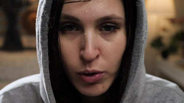 Workout at home. Beautiful young woman does cardio exercise with all her strength, close-up of face of very sweaty and tired woman. Close-up and slow motion