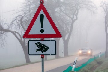 As common frogs enter mating season warning signs are erected for drivers on country roads in Germany.