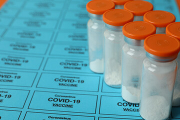 Vials of powder Covid - 19 vaccine on blue background