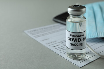 Concept of Covid - 19 vaccination with vial of vaccine, space for text