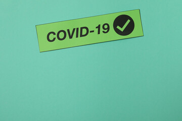 Text Covid - 19 on mint background, space for text