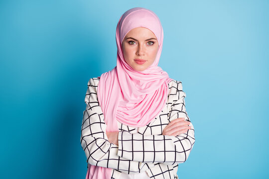 Photo of young beautiful muslim woman crossed hands confident smart wear hijab isolated over blue color background