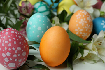 Fototapeta na wymiar Color Easter eggs and alstroemeria flowers, close up