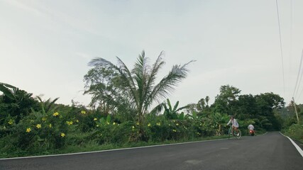 Biking road trip. The woman on blue bike in white clothes on forest road. The girl ride on bicycle. Cycling Cycle Fix. Asia Thailand ride tourism. Take a photo with a bike.