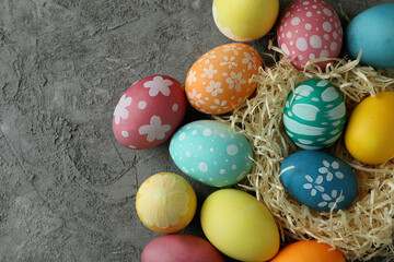 Fototapeta na wymiar Beautiful multicolor Easter eggs on gray textured background