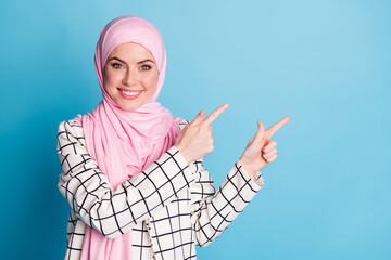 Portrait of attractive cheerful glad muslimah girl showing copy space advert solution isolated over...