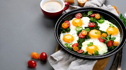 Fried eggs in frying pan for breakfast. Grey background