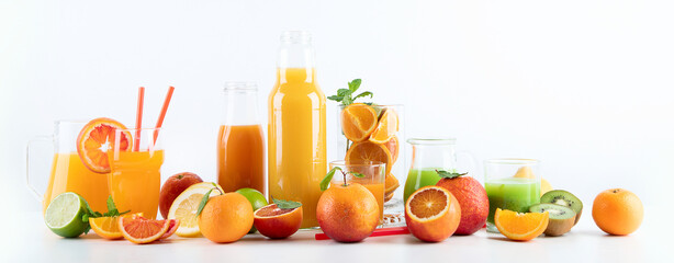 Raw fresh citrus juices and fruints in glasses and bottles