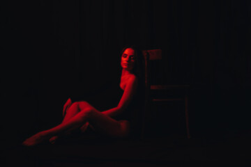 blurry portrait of a young sexy woman in a black bodysuit