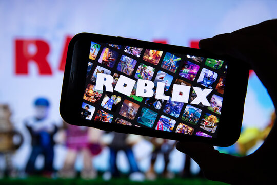 LONDON, UK - March 2021: Person holding a smartphone with Roblox game logo  Photos | Adobe Stock