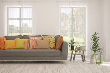 White living room with sofa and summer landscape in window. Scandinavian interior design. 3D illustration