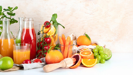 Healthy home made juices and fruits on light wooden background