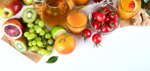Healthy home made juices and fruits on light wooden background