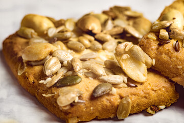 Homemade cookies with cereals and nuts on a marble table close up