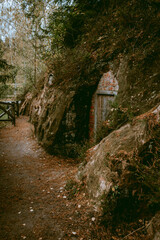 Cellar cliffs in Cave Rock (Lustuzis) in Ligatne, Latvia during cloudy autumn day that were used for storage of goods