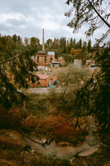 Overview of the Ligatne paper mill by the Ligatne River in Ligatne, Latvia during cloudy autumn day