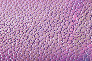 Scaly texture of pink artificial leather close-up