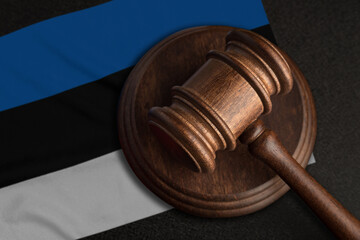 Judge gavel and flag of Estonia. Law and justice in Estonia. Violation of rights and freedoms