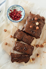 Sliced homemade chocolate brownie pastry with hazelnut. Top view. Healthy food concept