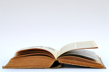 Open old book with text on white background