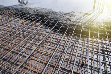 Pouring concrete onto a steel reinforced platform.
