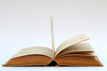 Open old book with text on white background