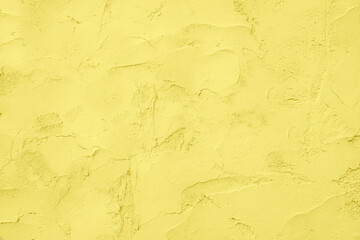 Yellow wall texture. Concrete wall with brush strokes and cracks.