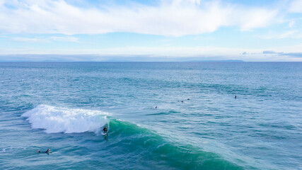 Aerial drone view of surfers riding perfect Atlantic waves in the south coast of Spain, Caños de...