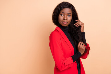 Photo of serious stunning pretty afro american young woman look empty space isolated on pastel beige color background