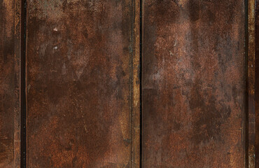Texture of old rusty grungy metal sheet. Uneven aged rough bumpy surface. Corrugated painted wall of smudged iron. Rusted hard pitted retro garage door. Vintage dirty destroyed roof for grunge design