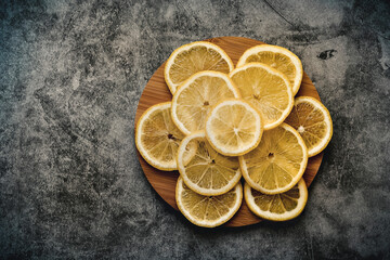 lemon slices on a round wooden board, space on the left side for writing